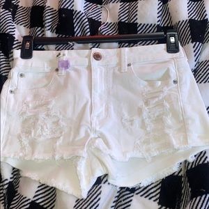 white ripped american eagle shorts